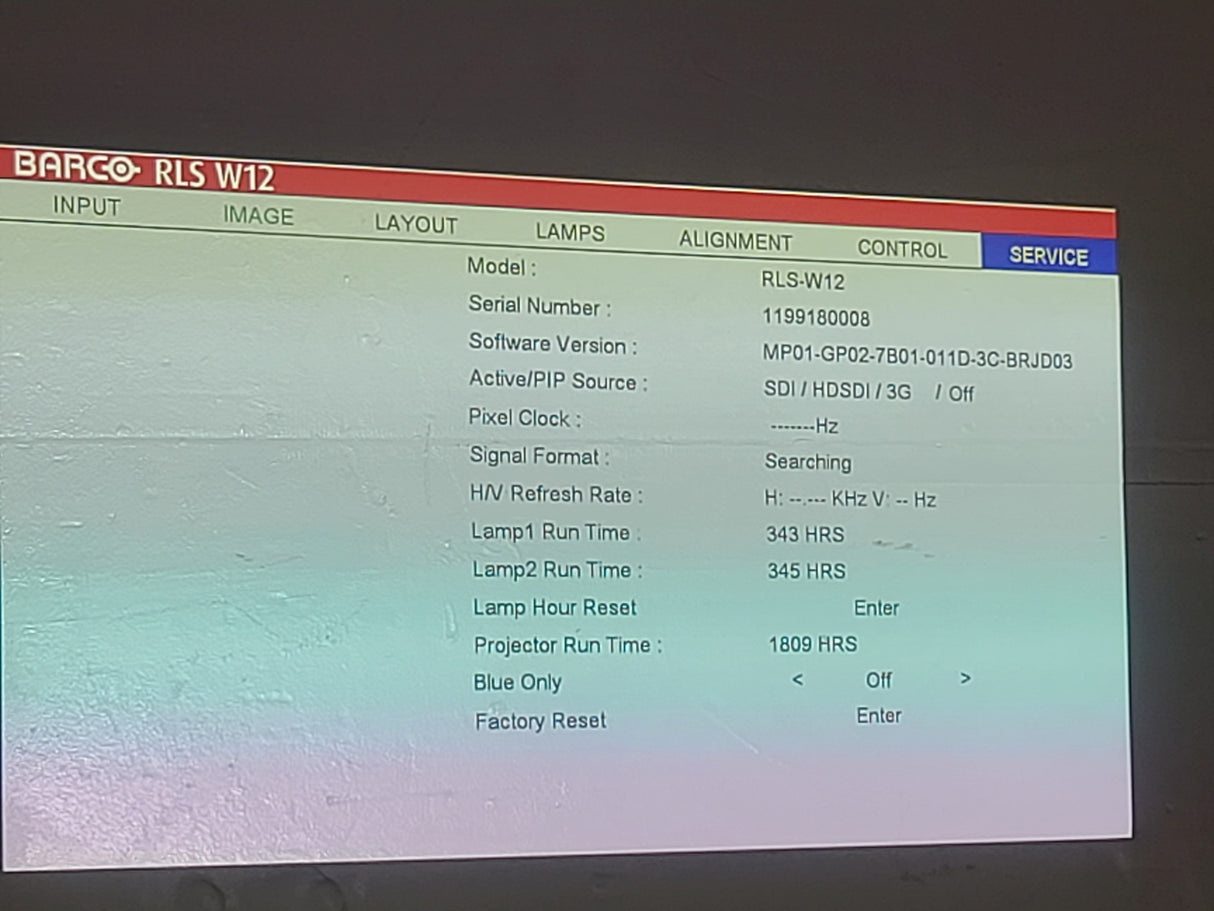 Barco RLS W12 11,000 Lumens WUXGA 1-Chip DLP (Lamp Hours 342 & 345) Large Venue Projector w/ (4) Mounting Clamps, Remote, Extra Lamp & PSU Cable in Wheeled Road Case (NO LENS)
